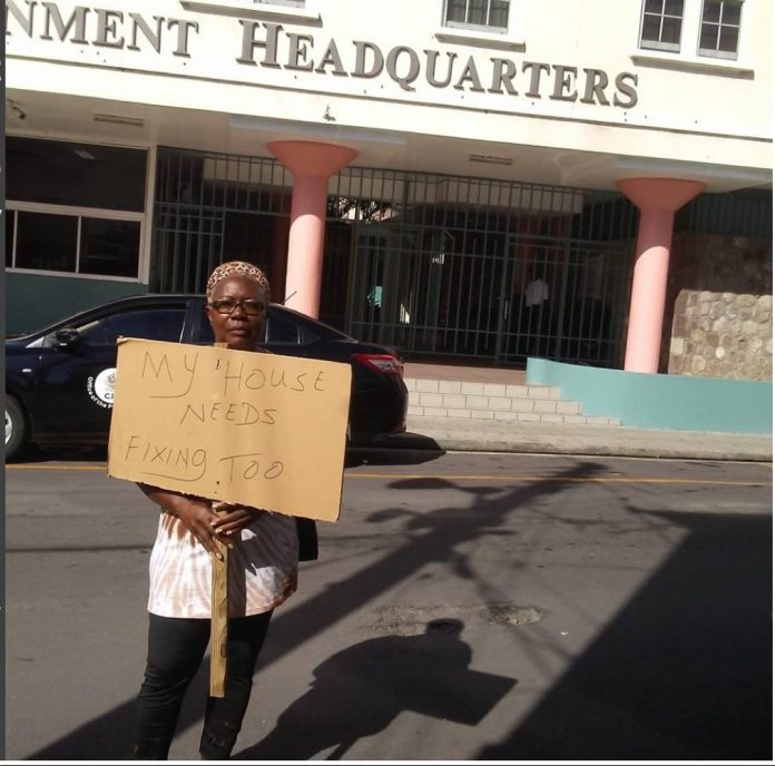 Adolphine-Woodley-protests-the-governments-roof-repair-programme.jpeg