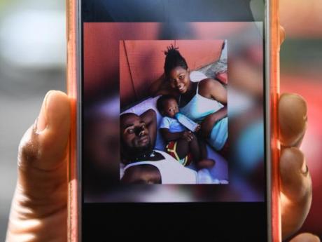 A cellphone displaying a photo of Jamaica Defence Force soldier Lexton Clayton (right), her boyfriend Kymani Taylor and their son Tyler. All three were found dead in St Thomas on June 7, 2020
