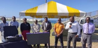 Troy Liburd receives delivery of Track and feild meet management system, Image Courtesy: Facebook