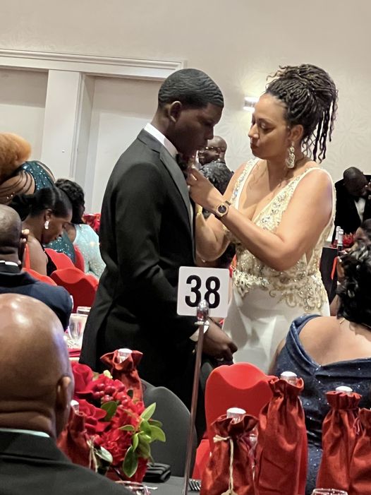 social media user captured a heartwarming moment between the Premier's wife and Prime Minister Dr Terrance Drew's son. Image Courtesy: Facebook