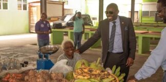 Samal Duggins enagages farmers in fruitful discussion during a walkthrough of Basseterre Public Market, Image Courtesy: SKNIS