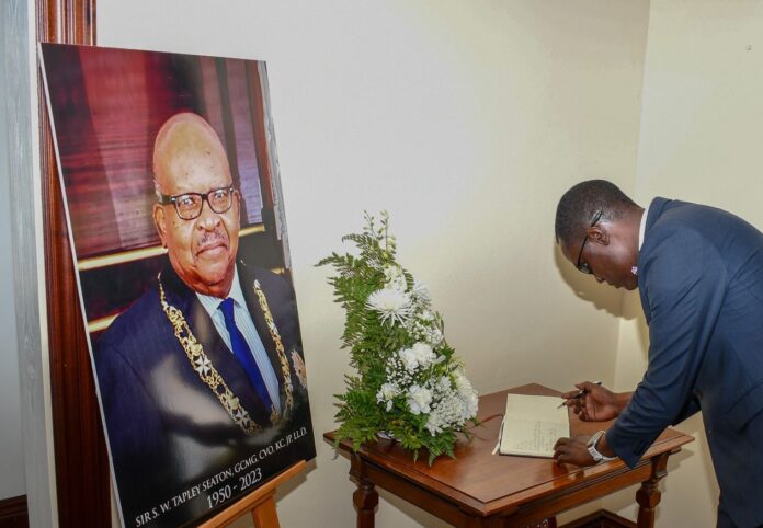 SKNRA Chairmman, Ricardo Neil signs book of condolences for S.W. Tapley Seaton, Image Courtesy: Facebook