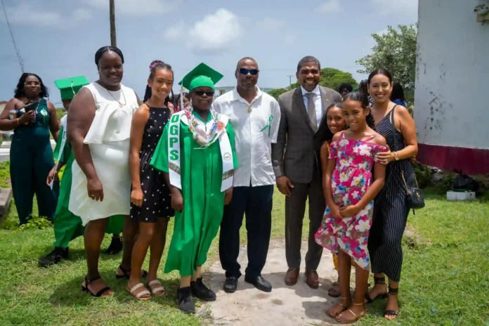 PM Drew extends congratulations to graduates of Dean Glasford Primary School, grants scholarship. Credits: Facebook.