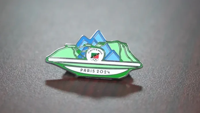 Artist Dennis Richards creates Olympic pin for athletes from St Kitts and Nevis. Credits: SKNOC.